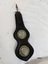 Leather Dropper with two metal rosette decorations and a metal clip at the top