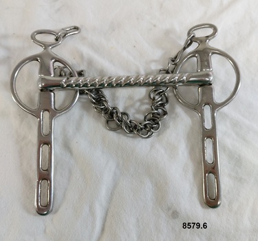 View of front of stainless steel horse bit showing grooved mouth bar