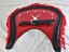Back of a red and black vinyl covered Housen showing the attaching strap and decorated with a red fringe and silver coloured studs
