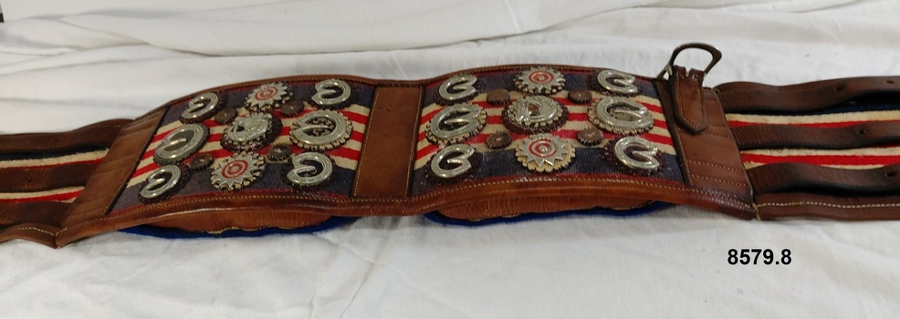 Leather and canvas padded harness backstrap with decorative silver ornamentation