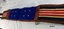 Underside of harness backband with red, white and blue striped canvas and leather strap and two blue fabric pads