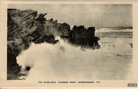 Waves crashing on rocky cliffs causing much sea spray
