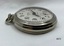 Side view of silver toned fob watch.
