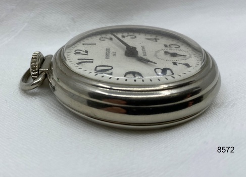 Side view of silver toned fob watch.