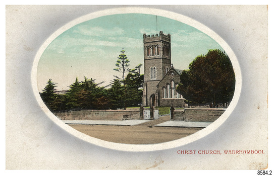 Rectangular postcard with oval cameo image of a stone church flanked be trees, behind a stone fence