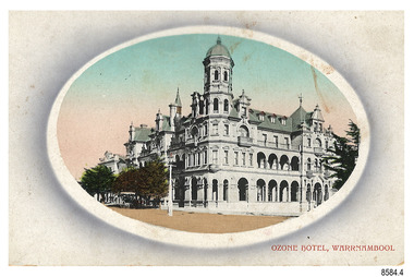 Rectangular card with oval cameo image of a three-storey building with arches, built on a corner