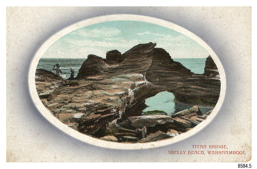 Rectangular postcard with oval cameo image of figurers on a rock formation beside the sea