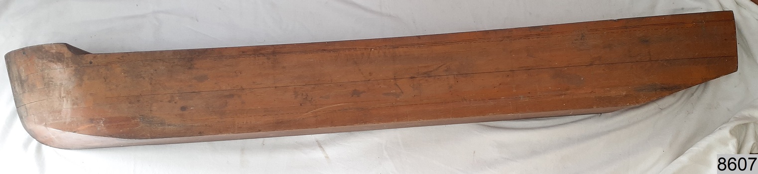 Laminated wood formed to make a half hull model of a ship, front view