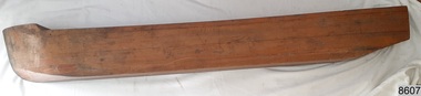 Laminated wood formed to make a half hull model of a ship, front view