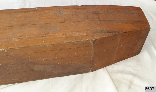 Laminated wood formed to make a half hull model of a ship, stern view