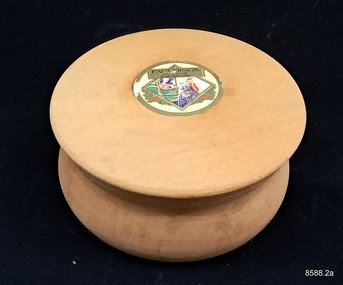 Round wooden box with lid, originally containing lavender powder.