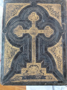Brown leather back cover embossed with gilt detailing