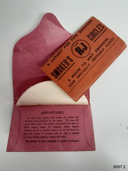 Two packets of Smoker's Circles comprising white round papers that are inserted into a pipe before smoking.