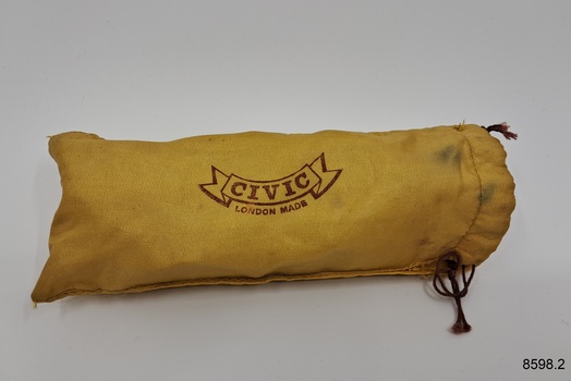 Yellow drawstring spectacle cover with stamped inscription