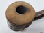 A collection of six pipes. Two of the pipes are resting in their protective cases. One of the pipes is the old fashioned clay type.