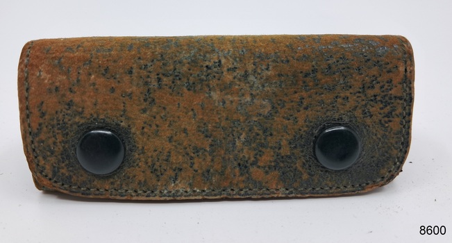 A brown leather coin pouch with the capacity to hold up to 12 coins.