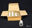 Rectangular cream cardboard box with partitions, and small glass bottles