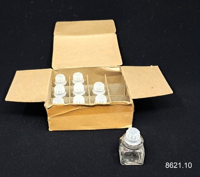 Rectangular cream cardboard box with partitions, and small glass bottles