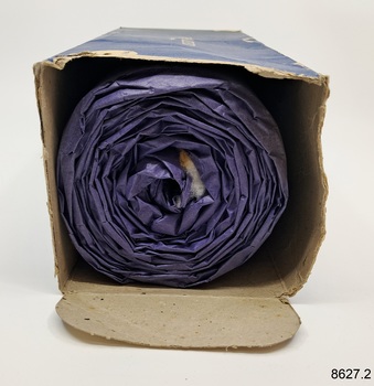 Profile of the rolled side of cotton wool inside an open-ended box. 