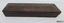 Wooden box is rectangular and protects the stone