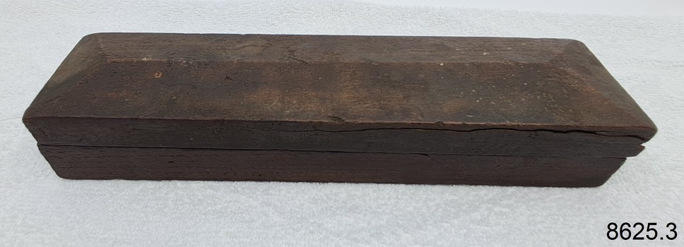Wooden box is rectangular and protects the stone