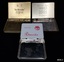 Three metal boxes, once containing cigarettes branded 'Ritmeester', 'Craven A' and 'De Reszke'.