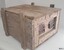 Wooden crate with metal handles at each end and a removable wooden lid