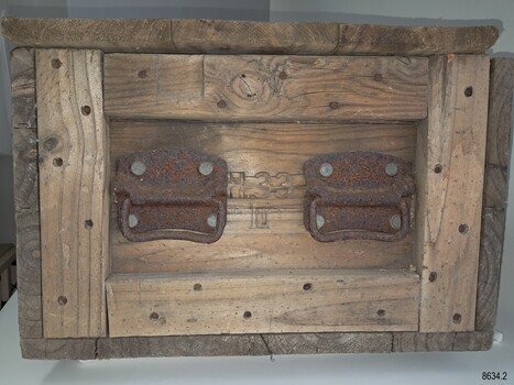 Inscription is stamped between the pair of metal handles
