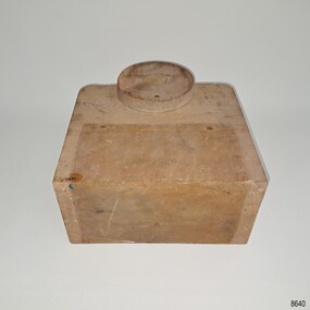 Thick unpainted rectangular block with curved corners on one side