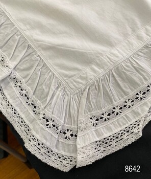 Edge view of pillowcase showing material and lace combination edging.