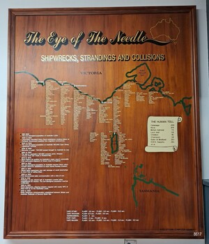 Wooden board in frame, displaying coastline of Victoria with locations of whipwrecks