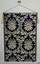 Dar blue and cream richly patterned brocade fumaric hanging from a rod with tastels.