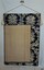 The reverse of the wall hanging is lined in cream fabric and has deep hems on top and right edge (when looking at reverse side)