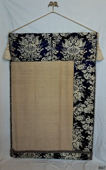 The reverse of the wall hanging is lined in cream fabric and has deep hems on top and right edge (when looking at reverse side)