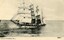 Postcard with black and white photo of a sailing ship with sails unfurled