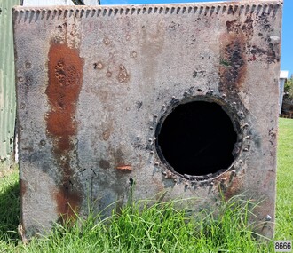 Square sheet of metal with rivets across the top and circular hole towards the right