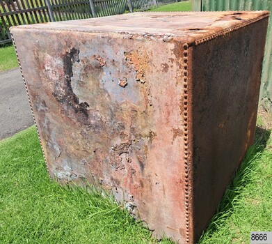 Panels overlap and are joined be rivets. Surface of side on left shows layers.