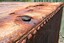 A round hole has been formed in the panel and has a wooden plug in it
