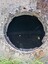 An additional round reinforcing ring has been rivetted inside the opening. It has several lugs on it.