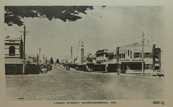 Street intersection with two storey buildings on each corners and buildings along the street