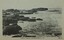 Rock shelf with shallow water beside rocky shoreline 