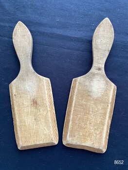 Pair of butter pats showing the flat side.