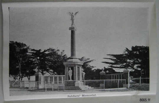 Memorial obelisk with angle on top flanked by plaques with lists of names