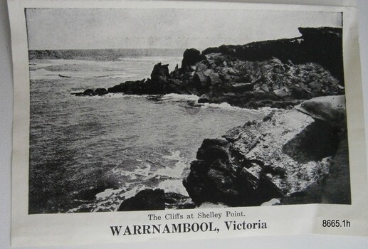 Ocean with waves breaking at the foot of cliffs