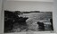 Figures on rocks beside a rocky ledge and the sea