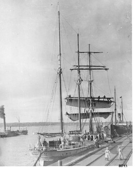 Black and white photograph  of two ships docked at Breakwater and another in the bay. 