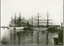 Black and white photograph showing two sailing ships moored at a dock
