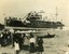 Black and white photograph of a crowd watching a steamer being launched 