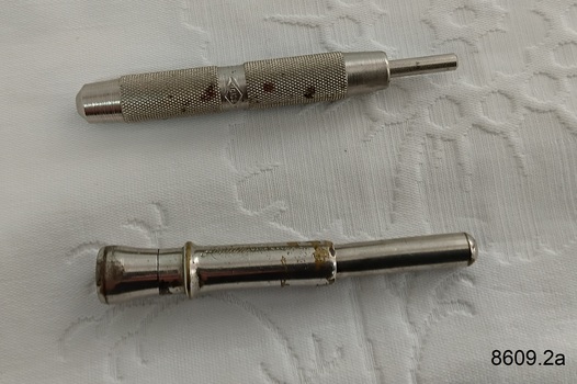 Two cigar piercers used to pierce the mouth end of a cigar so it can be smoked.