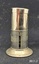 A two-piece round metal cigar piercer with a hollow spike in the middle of the base and a metal protective top.